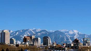 View of a city with snow-capped mountains in the background