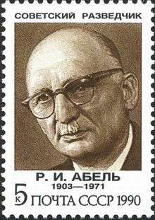 A reproduction of a stamp showing a drawing of a balding elderly man wearing glasses