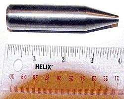 Shiny metallic cylinder with a sharpened tip. The overall length is 9 cm and diameter about 2 cm.