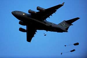 Two paratroopers dropping from a C-17 during an exercise