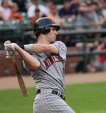 Joe Mauer follows through on a swing wearing Minnesota's road pinstripes