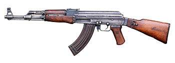 AK-47 assault rifle with curved magazine and wooden stock facing left