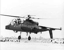 A quarter front view of a Cheyenne hovering in front of a crowd.