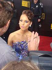 A woman being interviewed on the red carpet