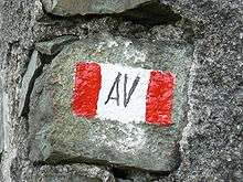 Rock with painted red-and-white flag and "AV" in center
