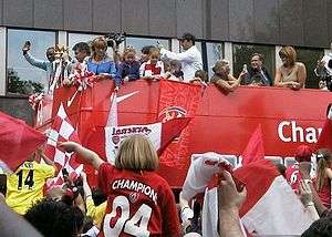 A photograph of Arsenal supporters celebrating the club's achievement with a parade which took place at Islington
