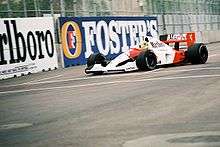 A picture of Ayrton Senna driving a McLaren MP4/6 formula one car during the 1991 United States Grand Prix.