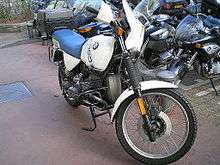 White BMW R100GS parked in front of some other motorcycles