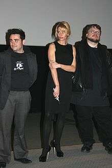 Juan Antonio Bayona, Belén Rueda and Guillermo del Toro dressed in black on a stage from left to right.