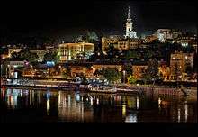 Belgrade at night, reflected in a river