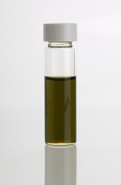 A vial containing a dark green-brownish oil