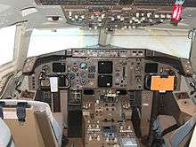 View of a 757 cockpit with six paired color displays.