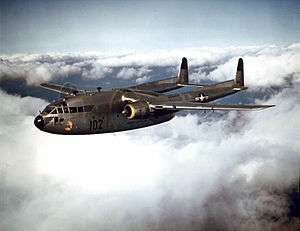 A stocky, unarmed military aircraft in flight