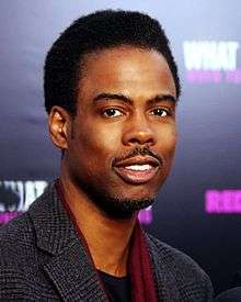 A photo of Chris Rock attending the premiere of the 2012 film What to Expect When Your Expecting.