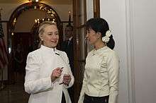 Clinton standing with Aung San Suu Kyi. The two women are discussing something during Clinton's 2011 visit to Burma.