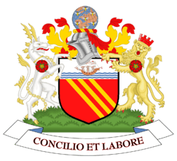 Gules, three bendlets enhanced Or; a chief argent, thereon on waves of the sea a ship under sail proper. On a wreath of colours, a terrestrial globe semée of bees volant, all proper. On the dexter side a heraldic antelope argent, attired, and chain reflexed over the back Or, and on the sinister side a lion guardant Or, murally crowned Gules; each charged on the shoulder with a rose of the last. Motto: "Concilio et Labore".