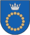 A coat of arms depicting a circle for which the boundary is itself made up of beige circles all under a silver crown on a blue background