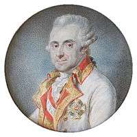 Painting of a slightly smiling white-haired man in a white military uniform with gold lapels and a Military Order of Maria Theresa Award. He wears his hair in late 18th century style with the hair curled over his ears.