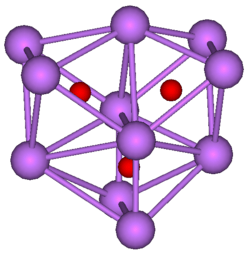  The stick and ball diagram shows three regular octahedra, which are connected to the next one by one surface and the last one shares one surface with the first. All three have one edge in common. All eleven vertices are purple spheres representing caesium, and at the center of each octahedron is a small red sphere representing oxygen.