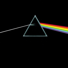 Original album artwork featuring an almost black cover with a triangular prism in the midddle. A ray of white light enters the prism from the left and is refracted into colours as it comes out the right side.