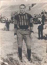 Kuhn, in uniform, on a grassy football field
