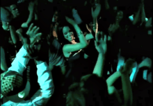 A screenshot of Rihanna dancing in a club