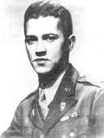 A young looking Caucasian man with dark hair and eyes in a US Army uniform with several decorations