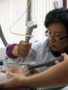 A physician performing laser resurfacing using an erbium laser