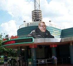 Larger than life figure of Carey's head and shoulders, posted above the studio entrance.