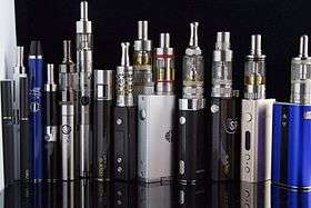 Displaying a variety of e-cigarettes standing next to each other.