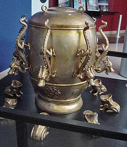 Picture of ornate urn-like device with spouts in the shape of dragons