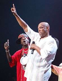Ecstasy and Flavor Flav onstage at a festival
