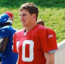 An American football player wearing a red jersey with a white number "10".