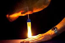 A piece of flash cotton is ignited by the sudden compression of a fire piston.