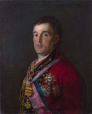 Painting shows a somber man with large round eyes. He wears a red military uniform with a large number of awards and decorations.