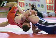 Two men in the U.S. military, one from the Air Force and one from the Marine Corps, compete in freestyle wrestling.