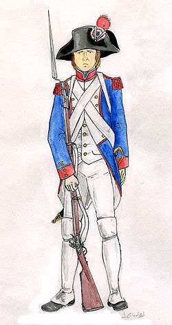 A French fusilier carries his long muzzled musket. He wears a blue jacket and white shirt and trousers; his cartridge belt is strapped across his chest and he wears a tri-cornered hat with a red revolutionary cockade.