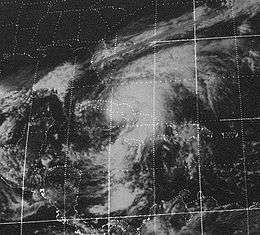 Satellite picture of a broad, sprawling tropical cyclone over the northern Caribbean. The southeastern United States are visible on the northwest corner of the map.