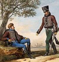 Print shows two hussars in black shakos and brown jackets with white lace and black fur trim. One sports sky blue breeches while the other wears brown trousers with white buttons up the side.