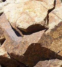 A buff-colored boulder of granite.