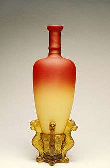 beautiful vase with consisting of red glass at top that fades to off-white at bottom