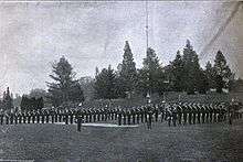 Uniformed men in formation on a field