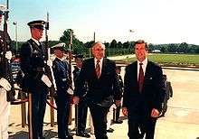 Photograph of Australian Prime Minister John Howard escorted by US Secretary of Defense William Cohen through an armed forces honor cordon into the Pentagon, June, 1997