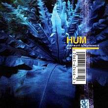A photograph of leaves tinted blue with the word "HUM" written in gold and "DOWNWARD IS HEAVENWARD" below that in white. The cover has a large UPC code across it and a simulation of a sticker attached to it.