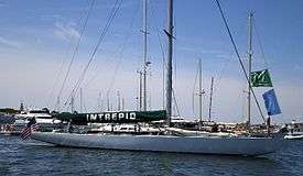 Photograph of the yacht Intrepid at her moorings, sails stowed.