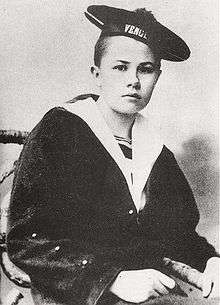 An androgynous photograph of Eberhardt as a teenager, sporting a short haircut and wearing a sailor's uniform.