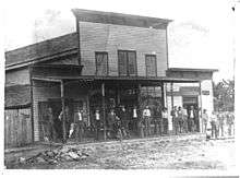J. M. Hall, his wife and two children in front of his store in Tulsa, 1896.