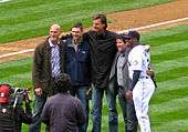 Randy Johnson in a black suit. To his left is Jay Buhner and Dan Wilson. To his right is Edgar Martínez and Ken Griffey, Jr.