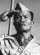 Filipino male in World War II Army Khaki uniform saluting.