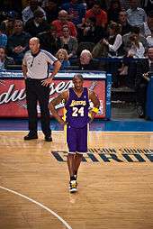 Kobe Bryant, in his Lakers uniform, standing on the basketball court at Madison Square Garden